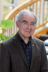 Elderly man in a brown blazer.