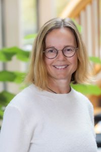 Woman with light hair in sweater